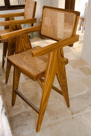 Joy Bar Stool made from durable teak wood with woven seat and backrest, ideal for kitchen islands, high countertops, and bar tables, handmade, stylish and comfortable seating for modern homes