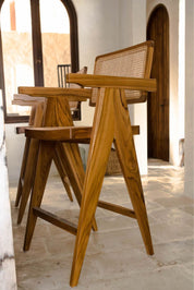 Joy Bar Stool made from durable teak wood with woven seat and backrest, ideal for kitchen islands, high countertops, and bar tables, handmade, stylish and comfortable seating for modern homes