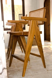 Joy Bar Stool made from durable teak wood with woven seat and backrest, ideal for kitchen islands, high countertops, and bar tables, handmade, stylish and comfortable seating for modern homes