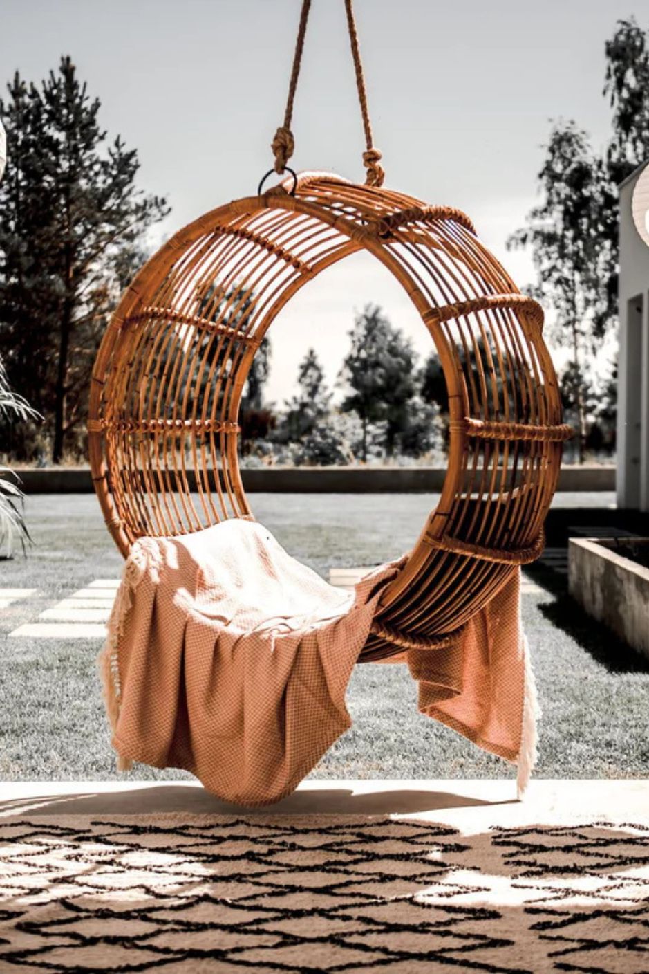Durable handmade cognac rattan hanging swing chair single, designed for relaxing indoor or outdoor comfort.