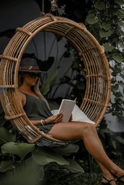 Durable handmade natural rattan hanging swing chair single, designed for relaxing indoor or outdoor comfort.