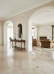 Luxurious interior with marble flooring, archways, and elegant furniture.