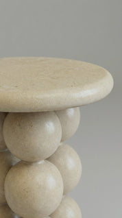 Beige spherical stool on a plain background