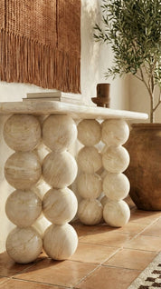 designer marble console table with sculptural base
