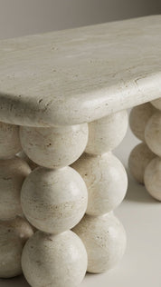 Stone table with spherical design on a neutral background