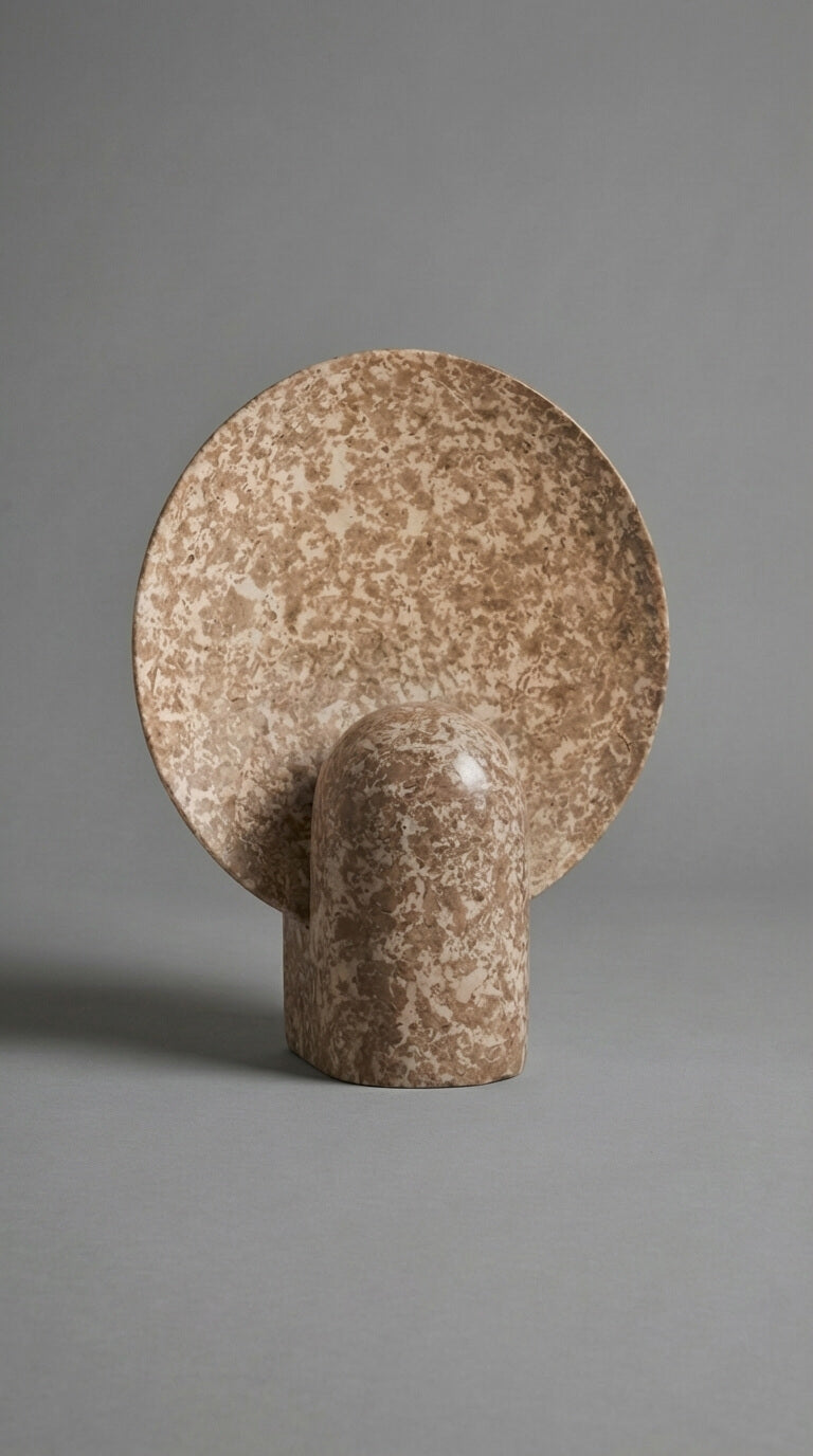 Brown ceramic wall hook on a gray background