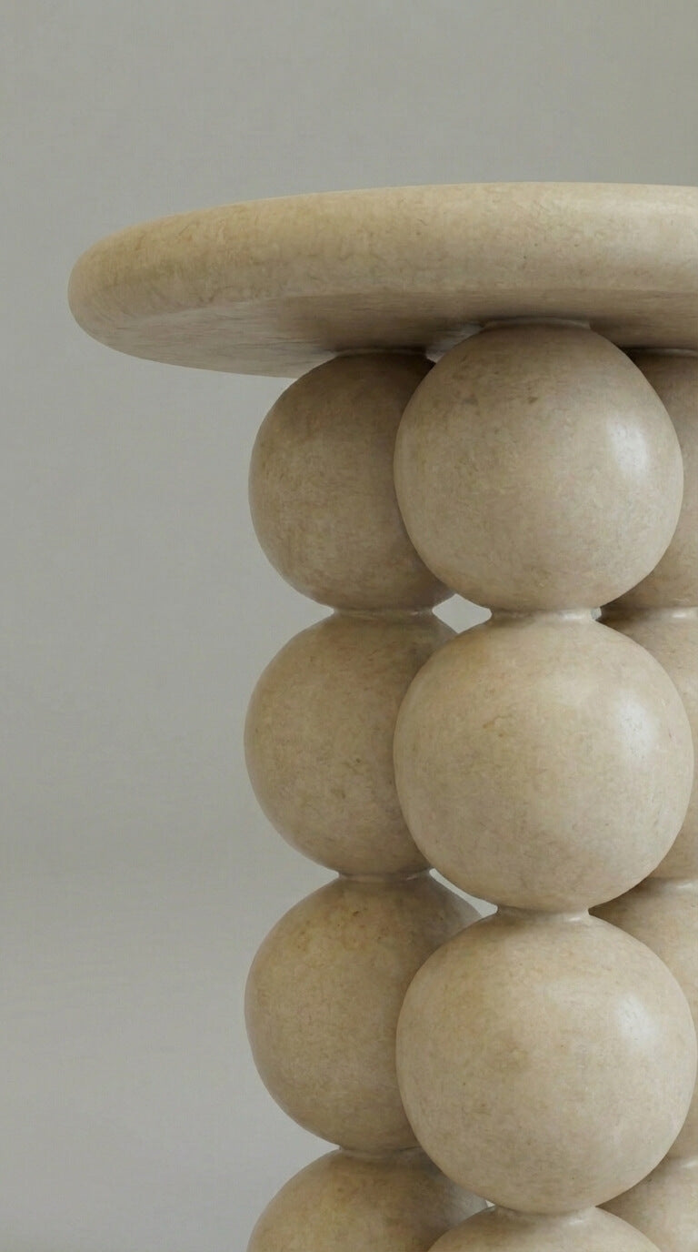 Beige spherical table against 