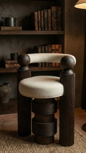 Teak wood armchair styled in luxury interior with white pillow
