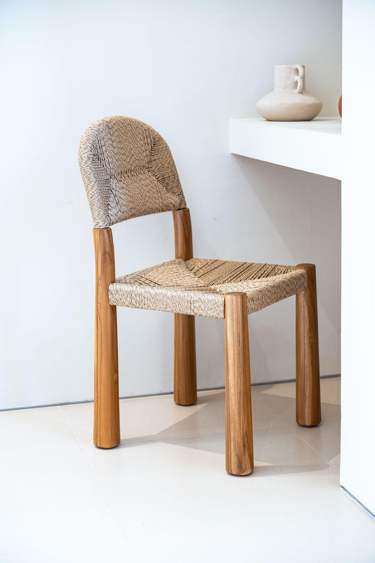 Wooden chair with woven seat and backrest in a minimalistic setting