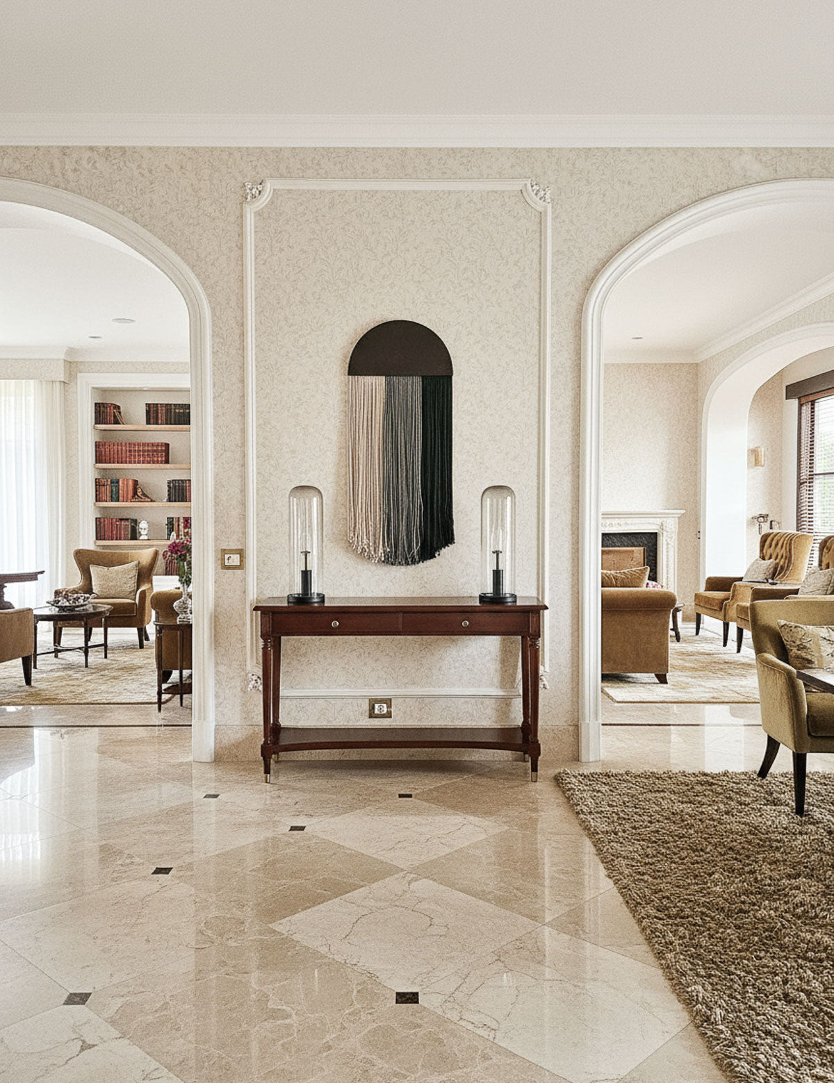 Luxurious interior with marble flooring, a console table, and armchairs.