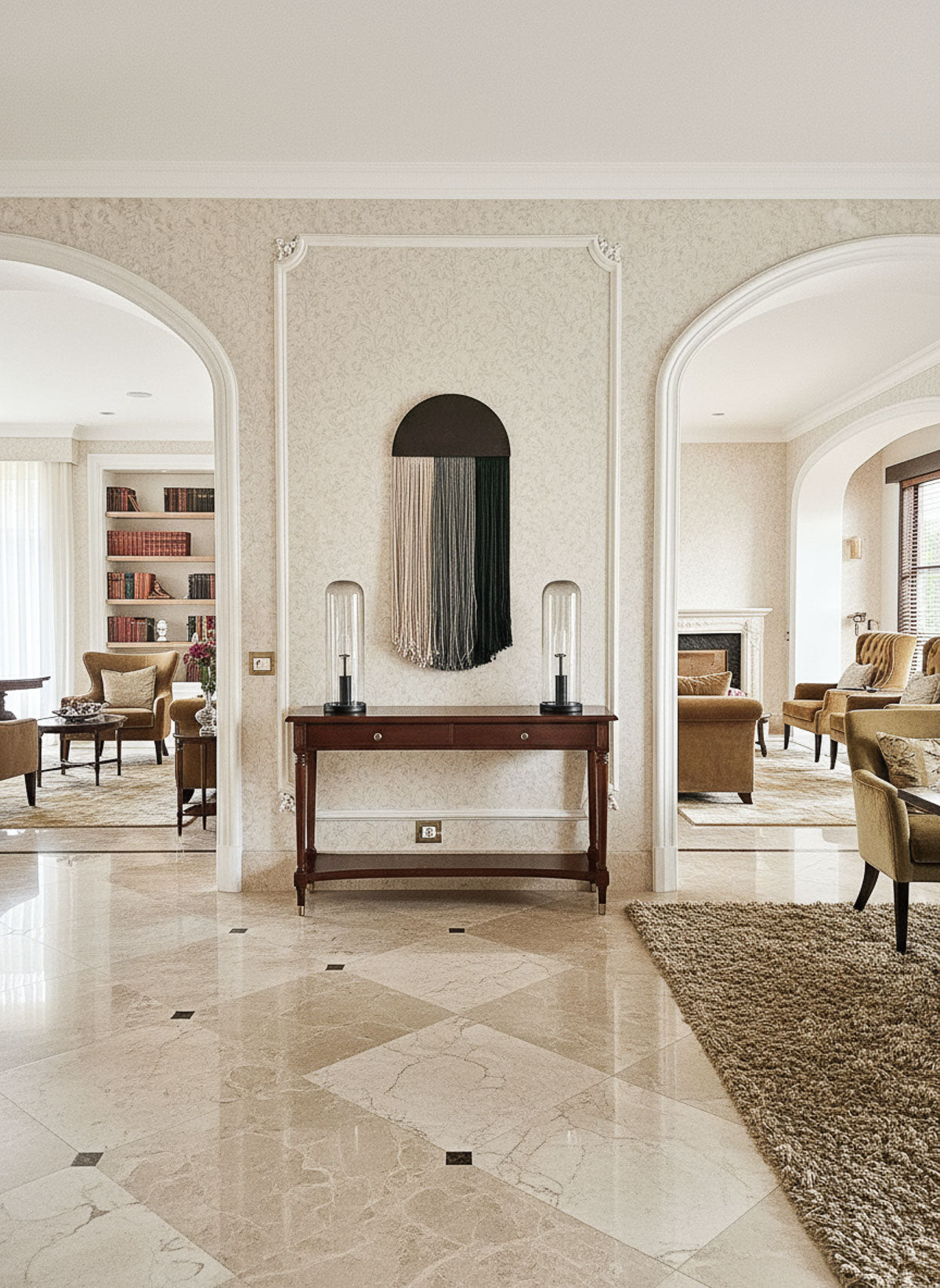 Luxurious interior with marble flooring, a console table, and armchairs.