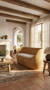 Woven rattan lounge sofa with curved base
