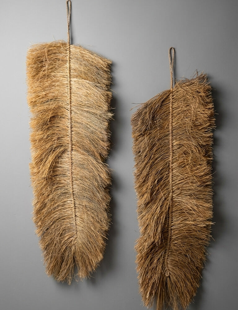 Two feather dusters against a gray background