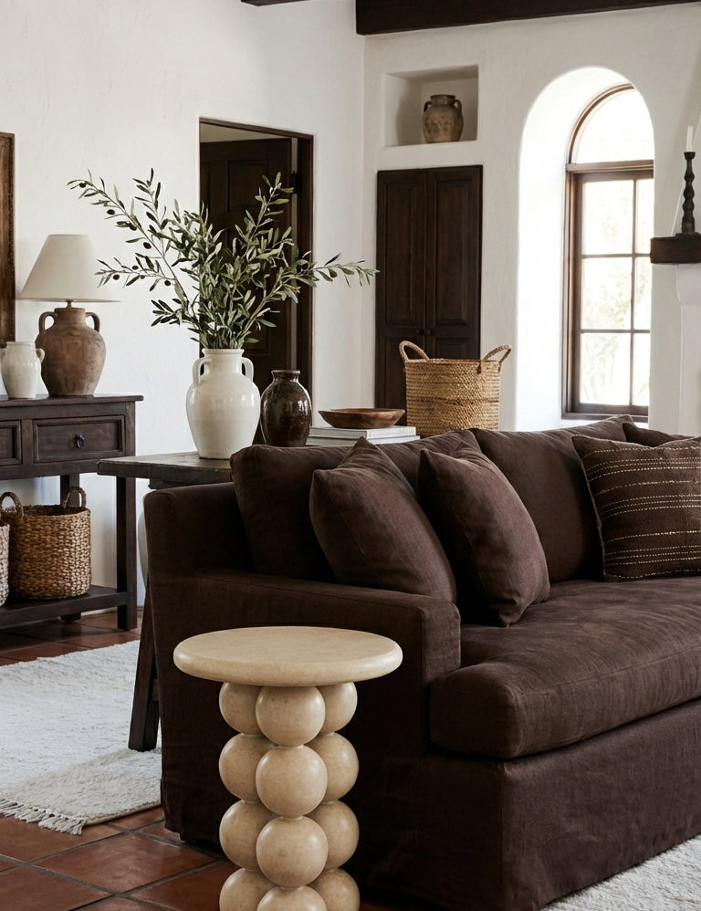 Living room with brown sofa, wooden coffee table, and decorative items.