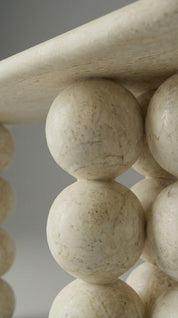 Close-up of a decorative stone baluster against a neutral background