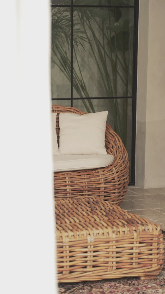Rattan lounge chair in modern coastal home
