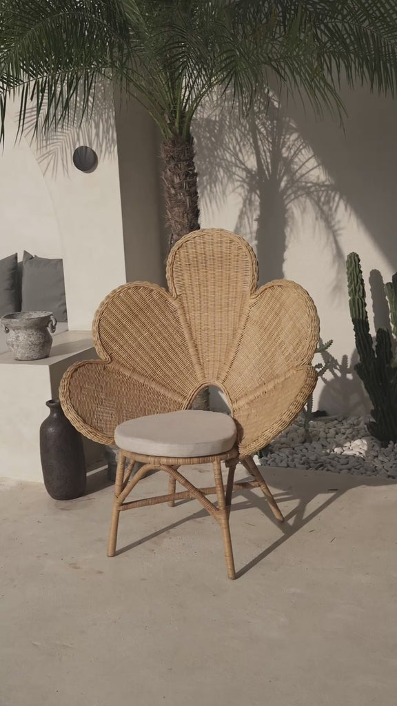 Rattan accent chair placed in bedroom interior
