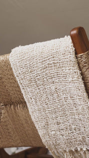 Solid teak wood lounge chair side view
styled in bright interior
