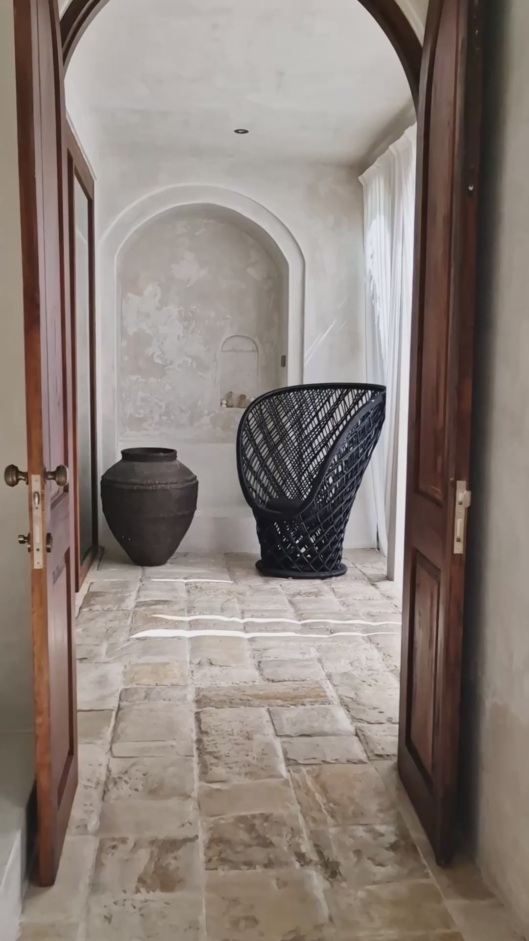 Statement rattan lounge chair with rounded frame
