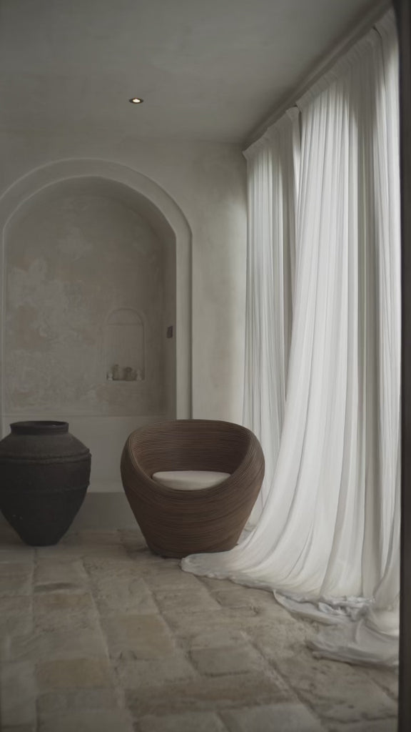 Designer rattan lounge chair with open weave
