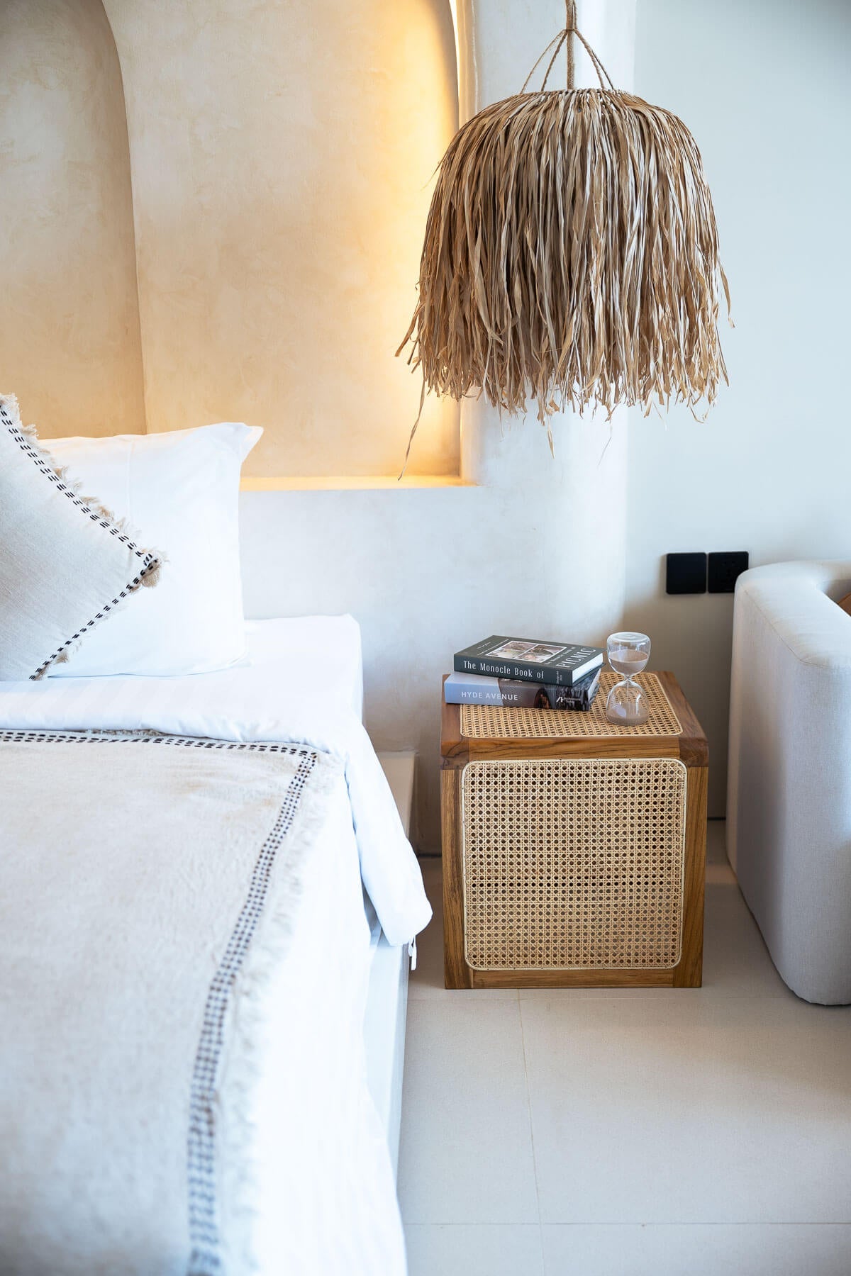 Bedroom with a bed, nightstand, and lamp in a cozy setting.