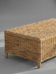 Wicker storage bench on a gray background