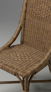 Close-up of a wicker chair with a neutral background