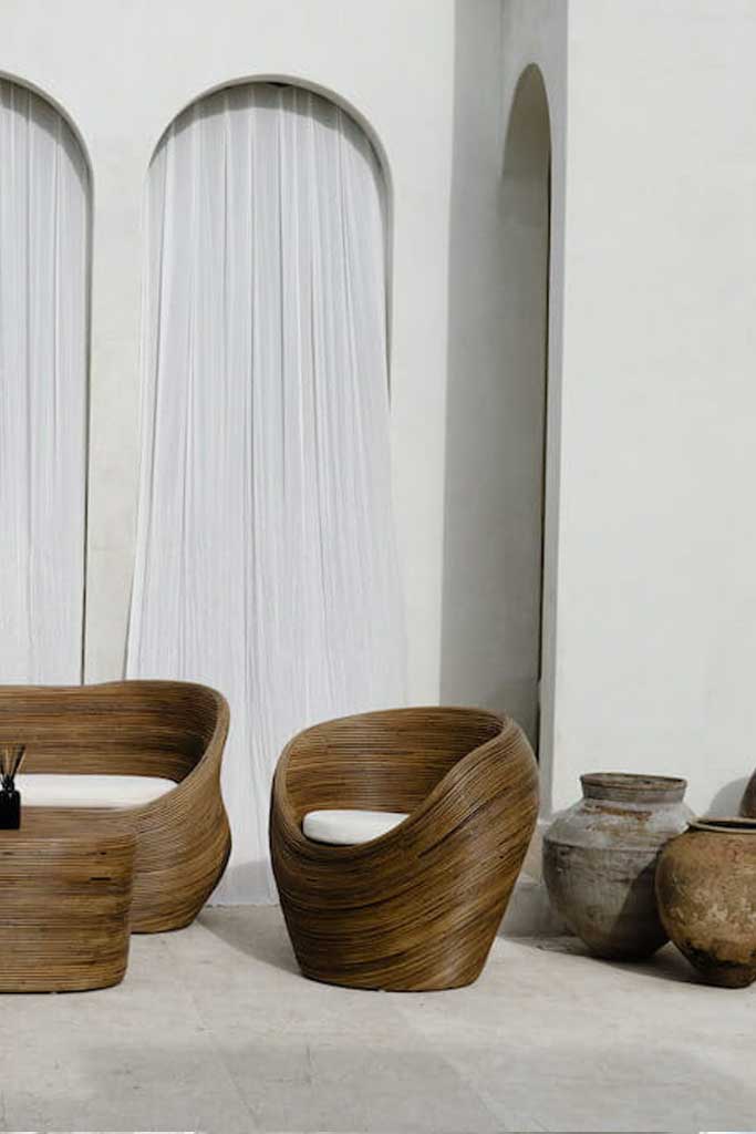 Handmade rattan armchair in dark brown with boho style, perfect for cozy living spaces