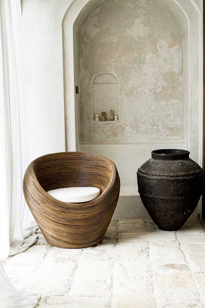 Handmade rattan armchair in dark brown with boho style, perfect for cozy living spaces