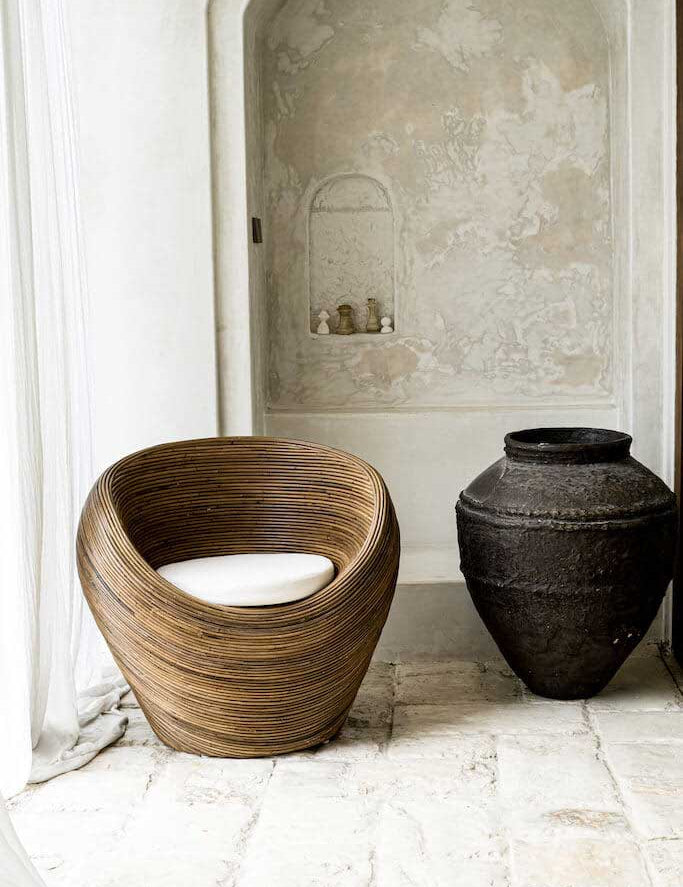 Handmade rattan armchair in dark brown with boho style, perfect for cozy living spaces