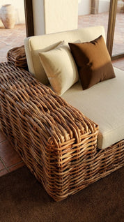 Wicker bench with cushions in a warm-toned interior setting