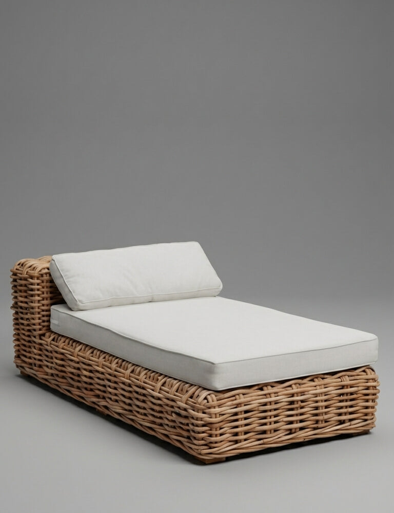 Wicker outdoor lounge chair with white cushions on a gray background