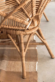 Rattan Monna Flower Chair featuring a handcrafted petal-shaped backrest and natural rattan weave, offering elegant bohemian style for indoor or outdoor spaces