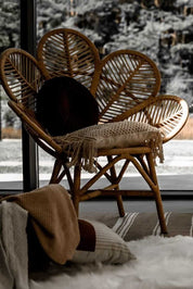 Rattan Monna Flower Chair featuring a handcrafted petal-shaped backrest and natural rattan weave, offering elegant bohemian style for indoor or outdoor spaces