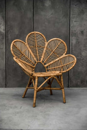 Rattan Monna Flower Chair featuring a handcrafted petal-shaped backrest and natural rattan weave, offering elegant bohemian style for indoor or outdoor spaces