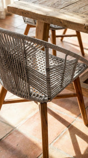 Teak wood dining chair in contemporary setting with rope
