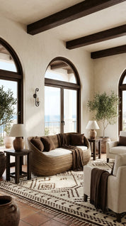 Living room with brown sofa, white armchair, and decorative elements.