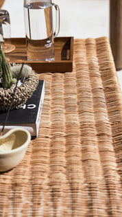 Sculptural rattan coffee table with rounded base
