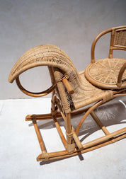 Wicker chair with a curved backrest on a light background