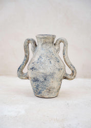 Ceramic vase with two handles on a light background