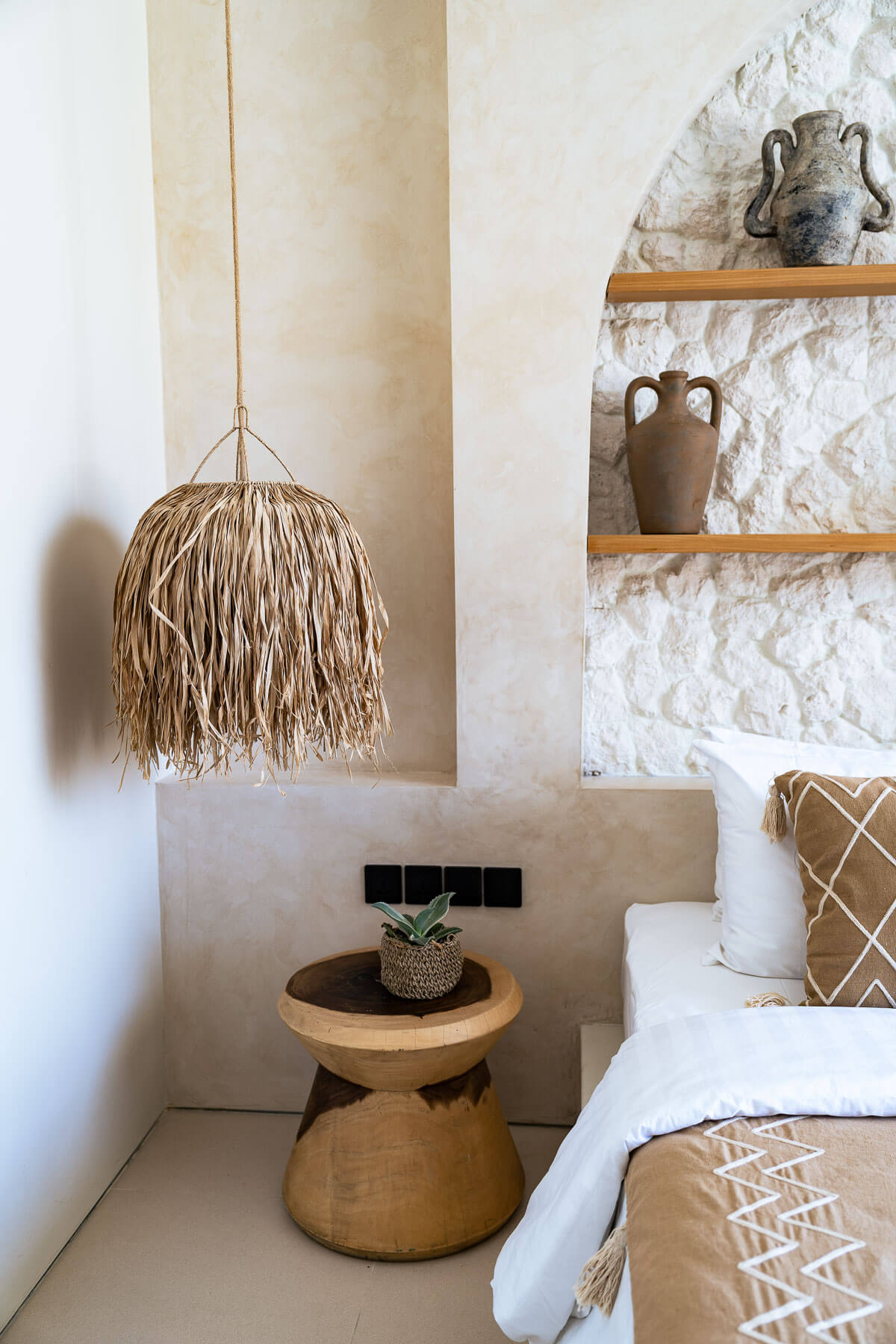 Nautical-themed room with wooden shelf, hanging lamp, and decorative items.