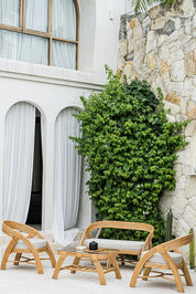 Handcrafted Sali sofa made from natural rattan with elegant flowing design and neutral tones, showcasing artisanal craftsmanship and timeless style.