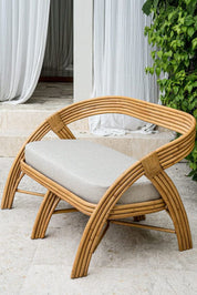Handcrafted SALI sofa made from natural rattan with elegant flowing design and neutral tones, showcasing artisanal craftsmanship and timeless style