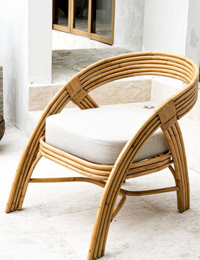 Handmade Sali rattan chair with opalescent autumn tones, cubic design, and soft seat cushion, perfect for natural and boho-inspired interiors.