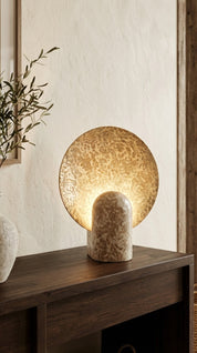 Decorative table lamp with textured design on a wooden surface.