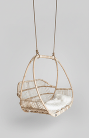 Woven hanging chair with a white cushion Natural rattan with handcrafted detailing
