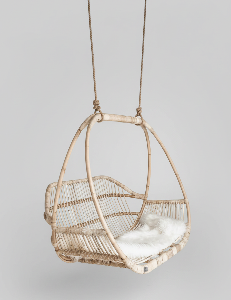 Woven hanging chair with a white cushion Natural rattan with handcrafted detailing
