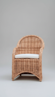 Wicker armchair with a white cushion on a gray background