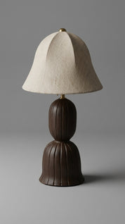 Table lamp with a brown base and beige shade on a gray background