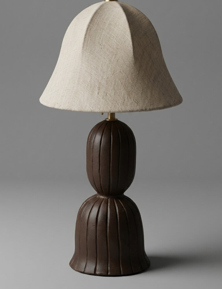 Table lamp with a brown base and beige shade on a gray background